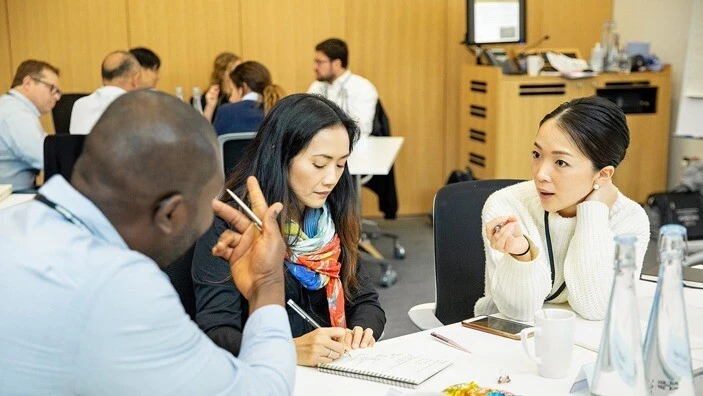 Attendees engaged in discussion during a transformational leadership workshop.