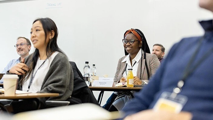 Participant smiling during an Executive Education session.