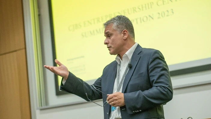 Stelios Kavadias gestures while presenting at the Entrepreneurship Centre.
