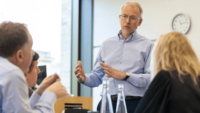 A facilitator engages with participants in an Executive Education session.
