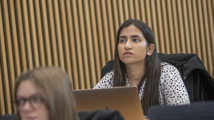 Woman in lecture theatre.
