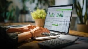 Finance, typing on laptop