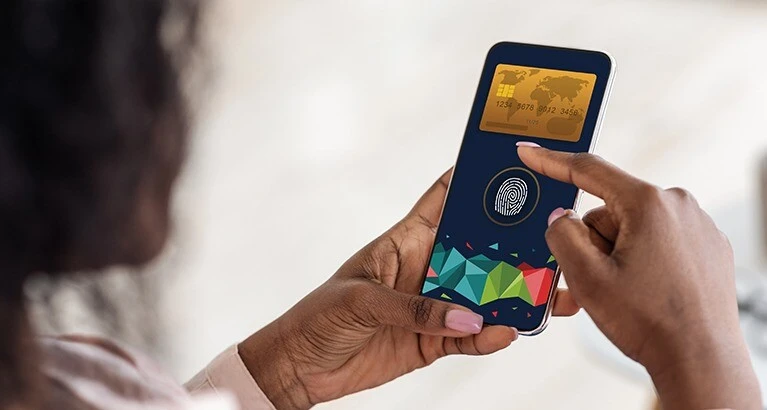 Woman making digital payment on her mobile device using biometric ID.