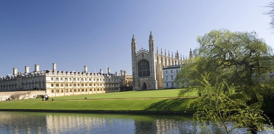 Spring time image of Kings and Clare College, taken from the Backs with River cam in the foreground.