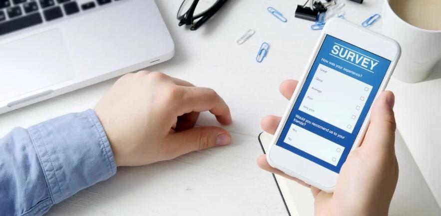 A survey participant looks at the questions on his mobile phone.