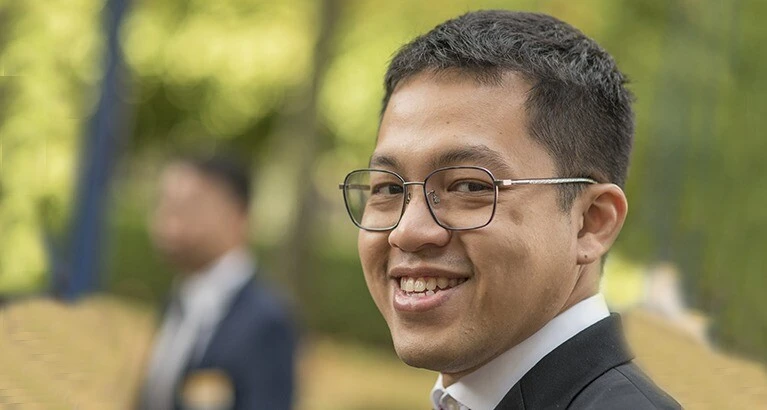 MBA student smiling outside.