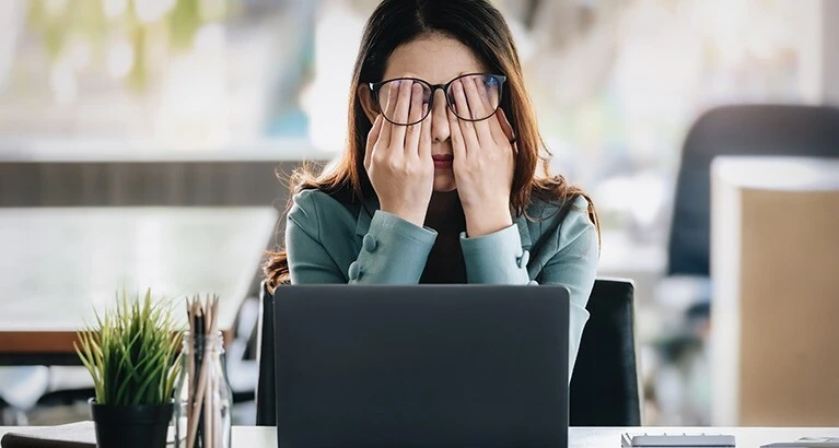 Woman rubbing her eyes.