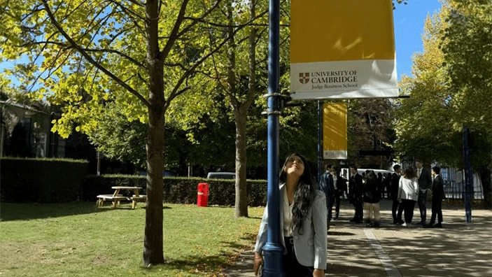 Aaryani Dogra posing with the school flag.