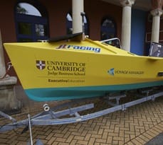 Yellow rowing boat marked with University of Cambridge and Executive Education branding.