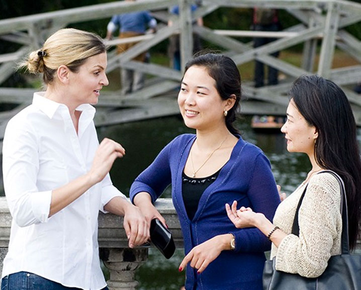 Three EMBA participants engage in conversation.