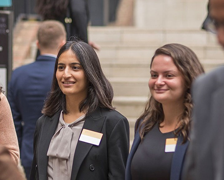 MBA students engaged in conversation at a networking event.