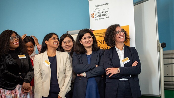 A group of women smiling during the EnterpriseWOMEN programme at the University of Cambridge.
