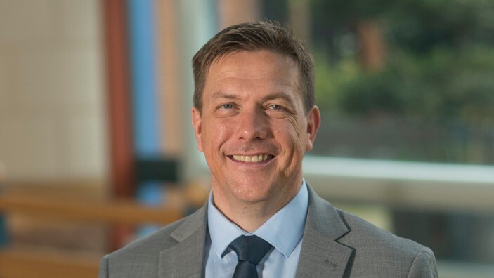 Angus Mugford inside the Cambridge Judge Business School Atrium