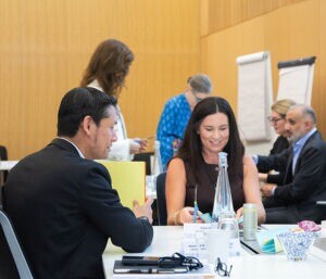 Woman and man chatting in a classroom in a group activity.