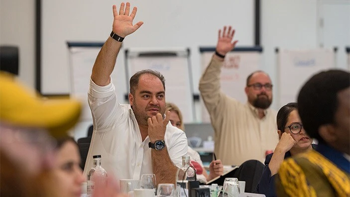 Leaders in the classroom asking for questions or wanting to answer. Raising hand.