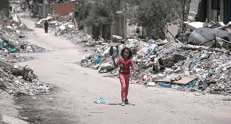 A girl walks inside Gaza during the Gaza-Israel war to get food.