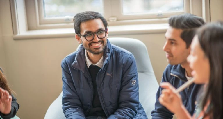 MFin student chatting with classmates.