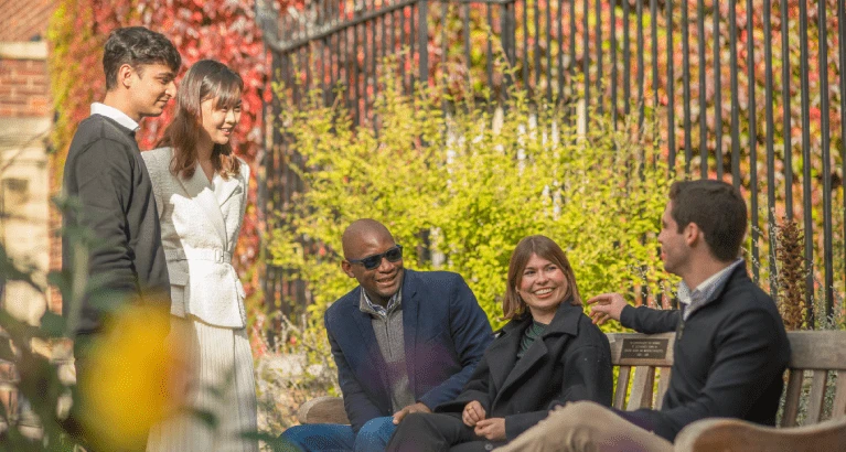 Cambridge MFin class of 2025 gathered together outside.