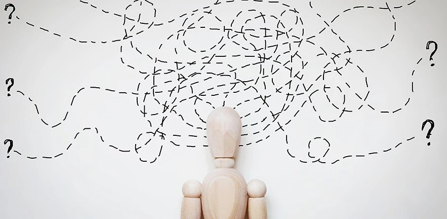 Abstract image with a wooden puppet - dotted lines and question marks.