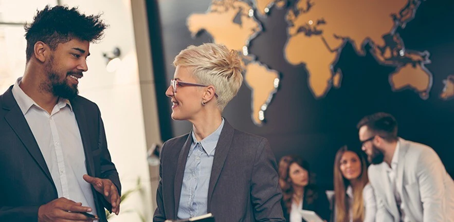 Academics collaborate in front of world map.