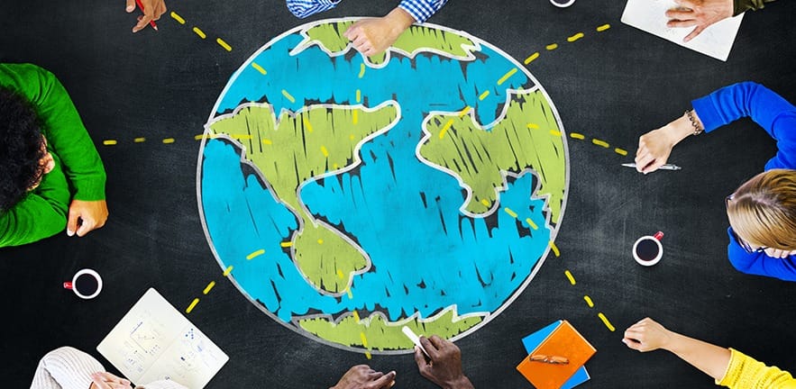 People working on a gloabl blackboard for a project.