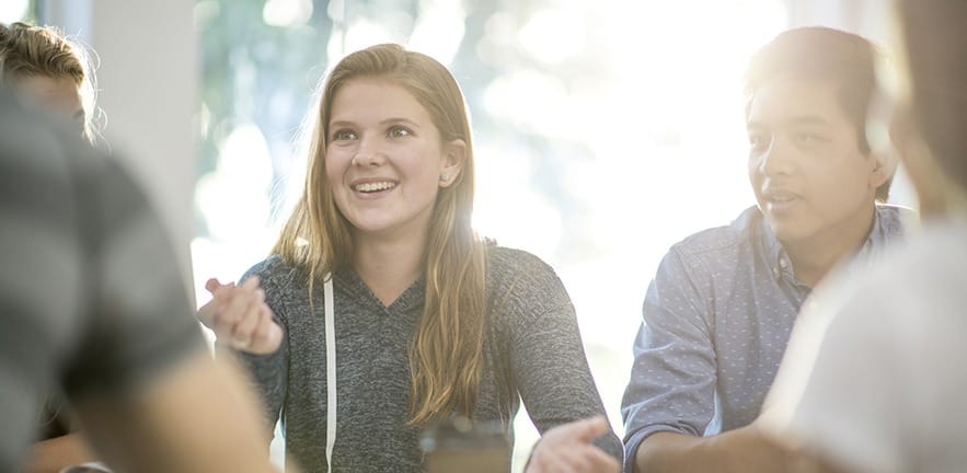 A group of college students are studying together after class on campus.