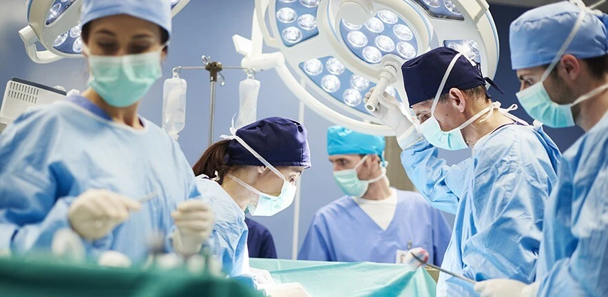 Group of surgeons in operating room.