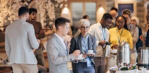Businesspeople taking a break to have a snack at the convention centre buffet.