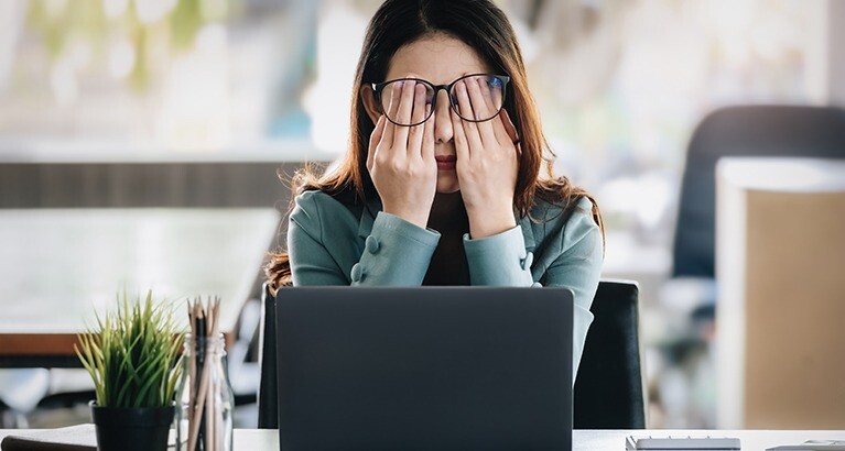 Woman rubbing her eyes.