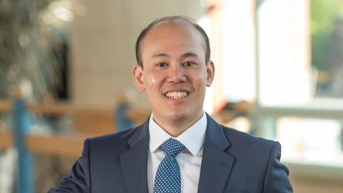 Calvin Liew inside the Cambridge Judge Business School atrium.
