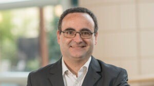 Carlos Fernandez Musoles inside the Cambridge Judge Business School atrium.