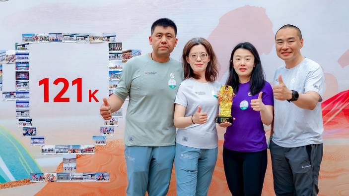Four Cambridge Judge Business School students and alumni holding a trophy at the Will of Nature - Gobi to West 2025 event.