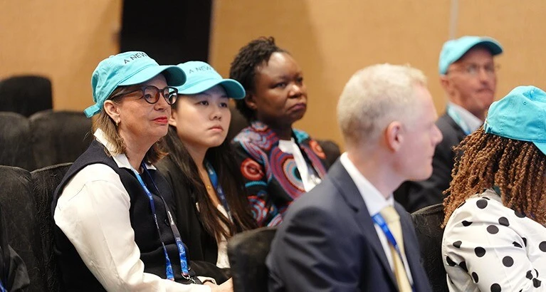 Wearing a new hat of solidarity for gender equity at the soft launch of the WRN at Insights Forum, Singapore, November 2025.