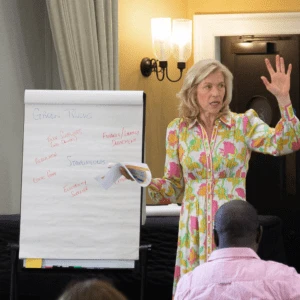 Professor Jennifer Howard presenting to class with whiteboard
