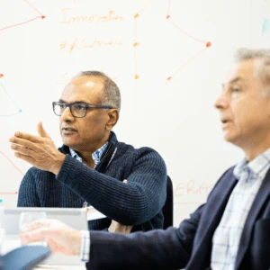 A senior leader asking the Professor a question in class