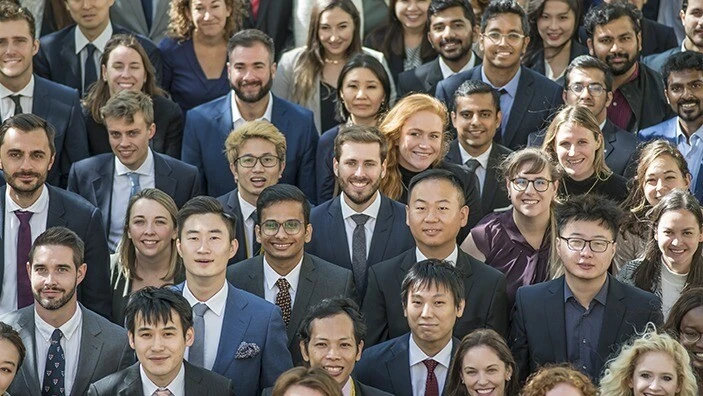 A diverse group of students in professional attire.