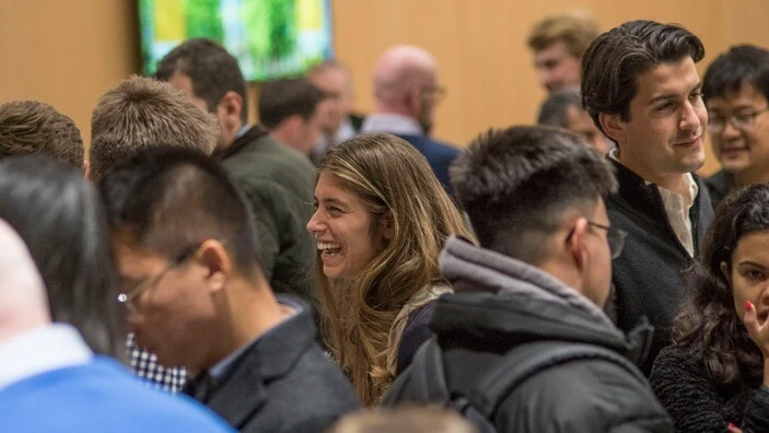 Attendees engaging in lively conversation during an Enterprise Tuesday networking event.
