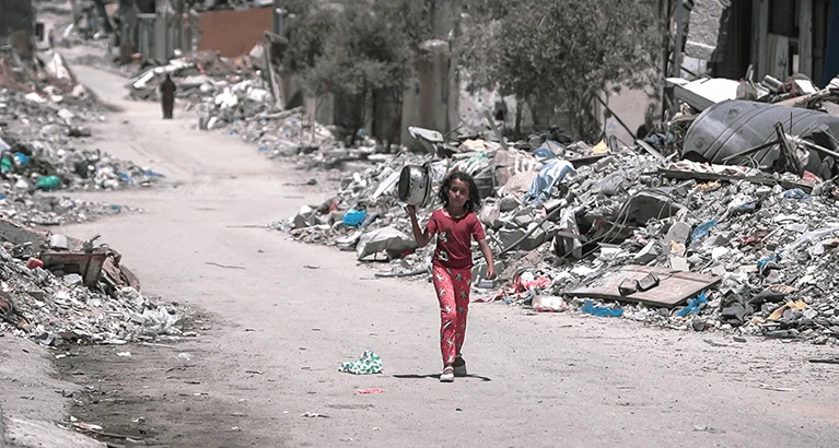 A girl walks inside Gaza during the Gaza-Israel war to get food.