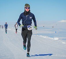 Greg Nance runs on snow-covered terrain during the World Marathon Challenge in Antarctica.