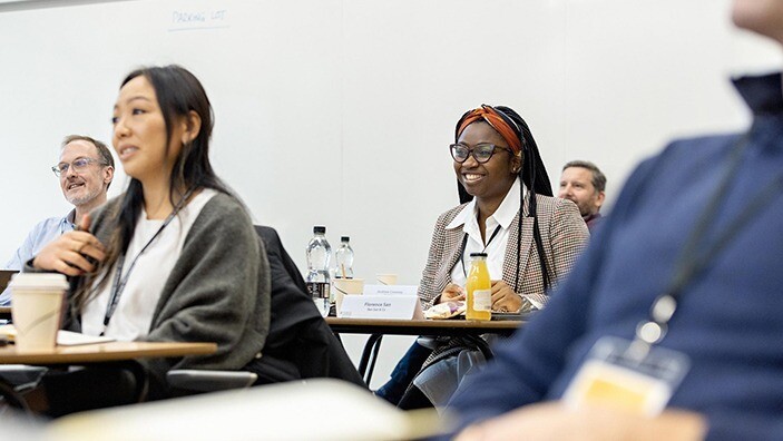 Participant smiling during an Executive Education session.