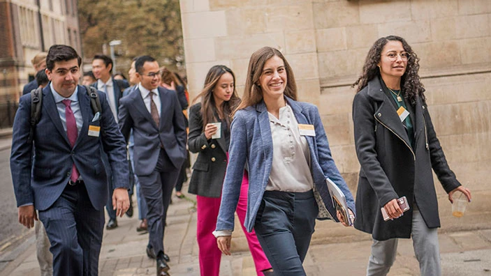Students walking together in Cambridge, engaged in conversation.