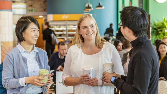 Three people engaging in conversation.