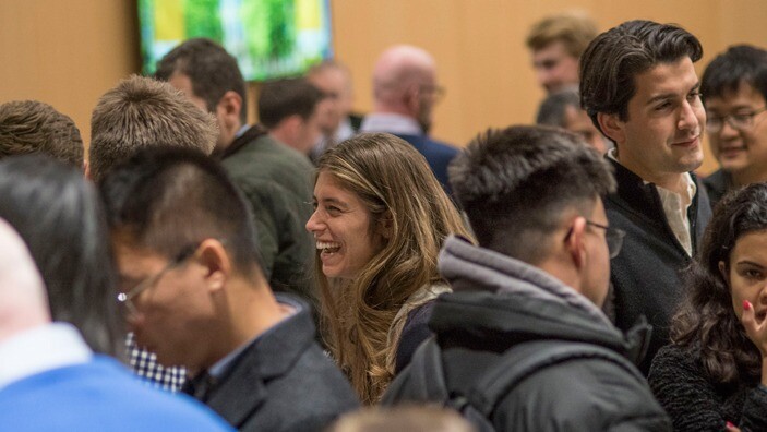 Attendees engaging in lively conversation during an Enterprise Tuesday networking event.
