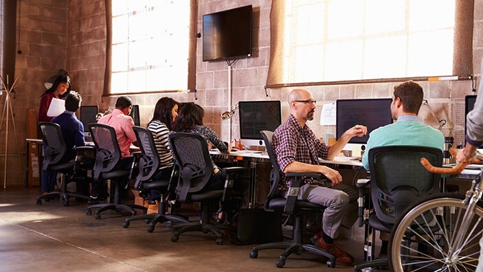 People collaborating in an open workspace.