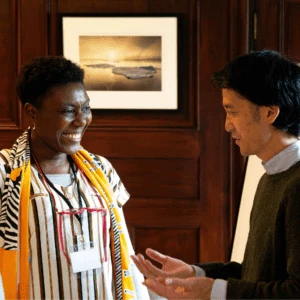 Two delegates networking and smiling in discussion