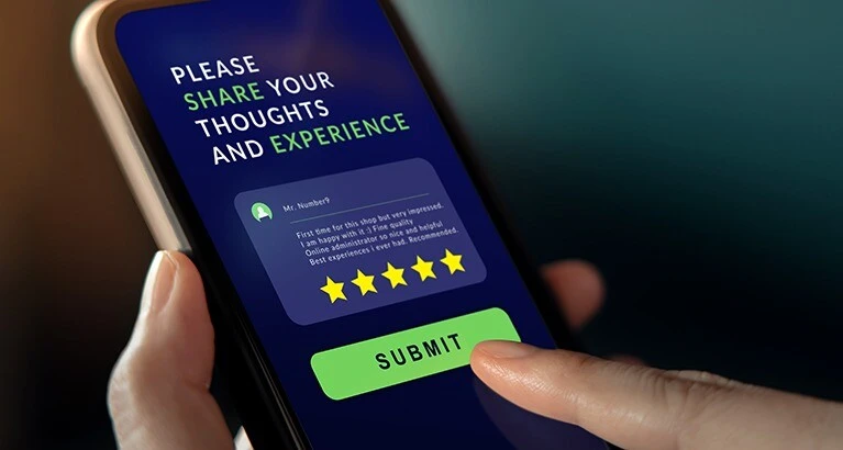 Person using a mobile phone to submit feedback online.