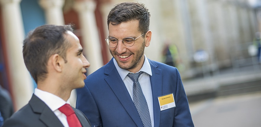 Two MBA students smiling and talking.