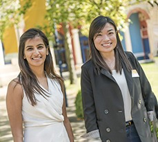 Two MBAs walking outside at the front of the School.