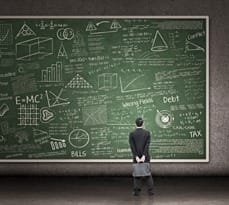 Businessman looking at hand drawn chalkboard