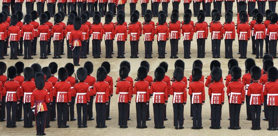 British guardsmen in traditional red tunics and bearskin hats, on parade in London